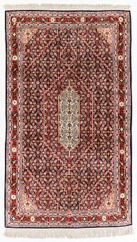 An oriental silk rug, c. 177 x 104 cm.