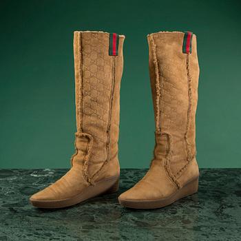 A pair of boots by GUCCI in size 39.