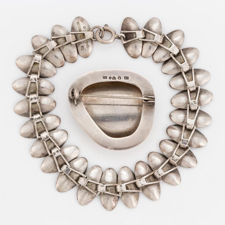 A 1950's silver bracelet and brooch.