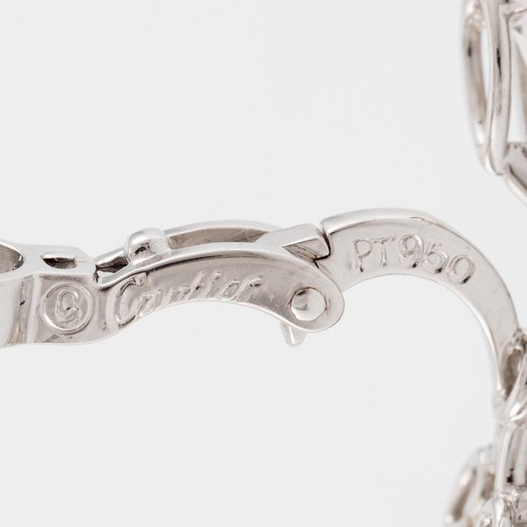 Cartier a pair of earrings platinum set with drop-shaped and round brilliant-cut diamonds.