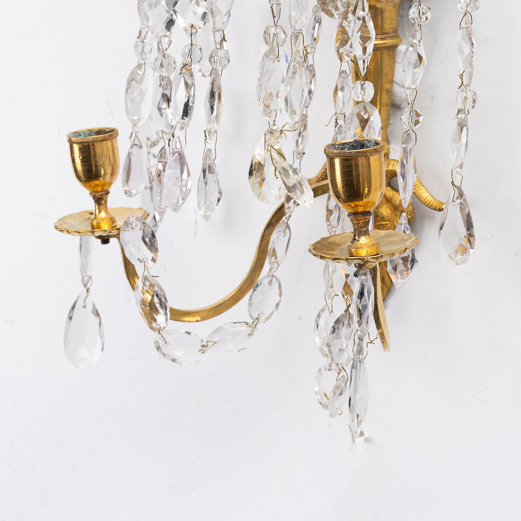 A pair of late Gustavian ormolu two-branch lustres, circa 1800.