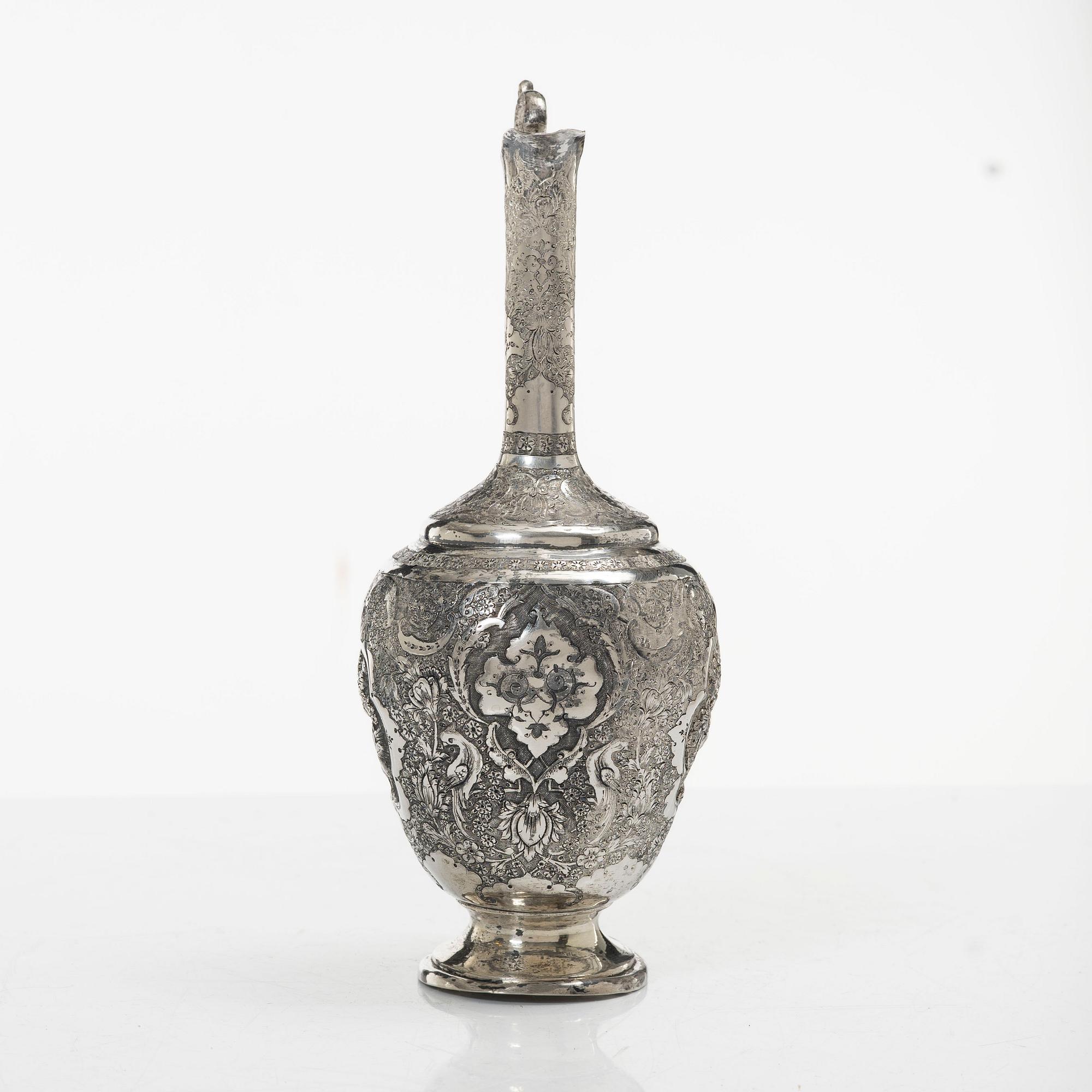 A Persian silver pitcher with five stemmed cups and a beaker, first part of the 1900s.