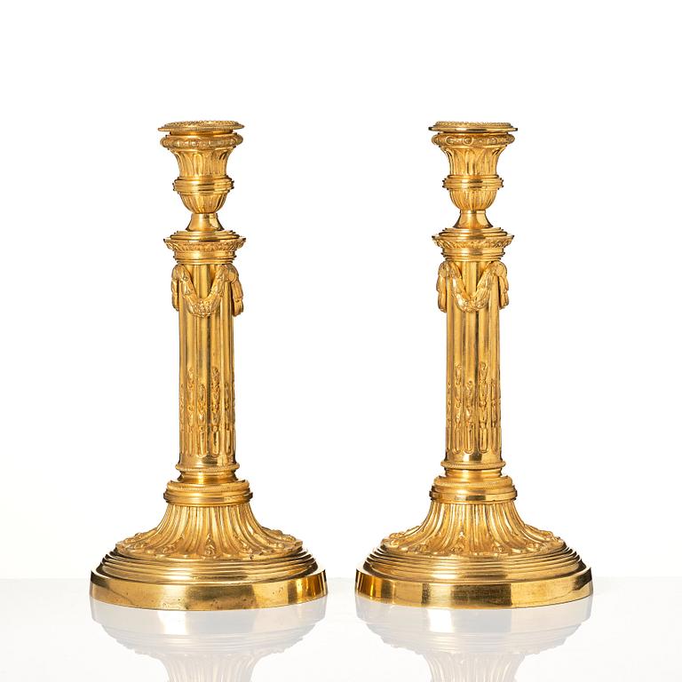 A pair of Louis XVI candlesticks in the manner of Jean Louis Prieurs.