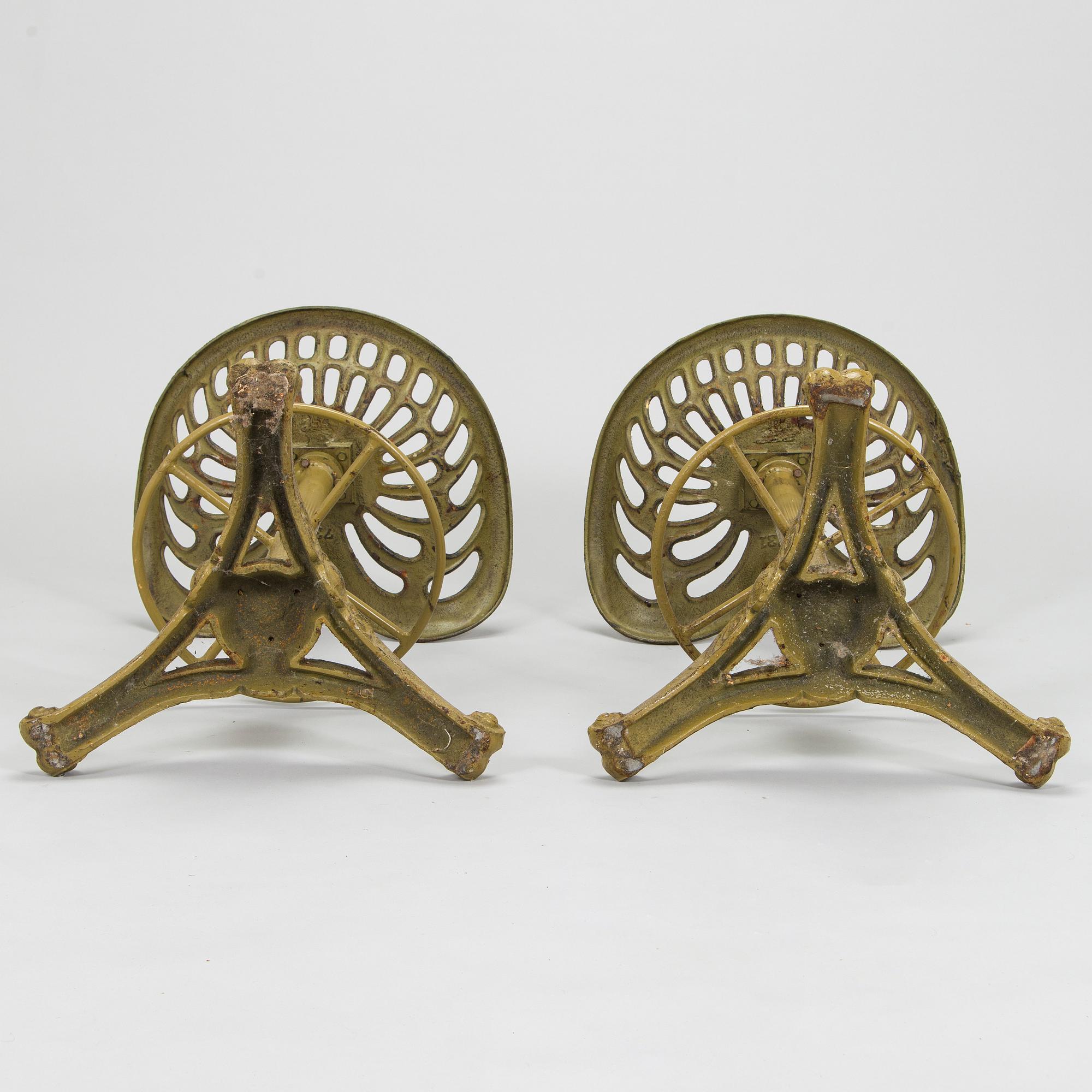 Four bar stools, painted cast iron, partly from the early 20th century.