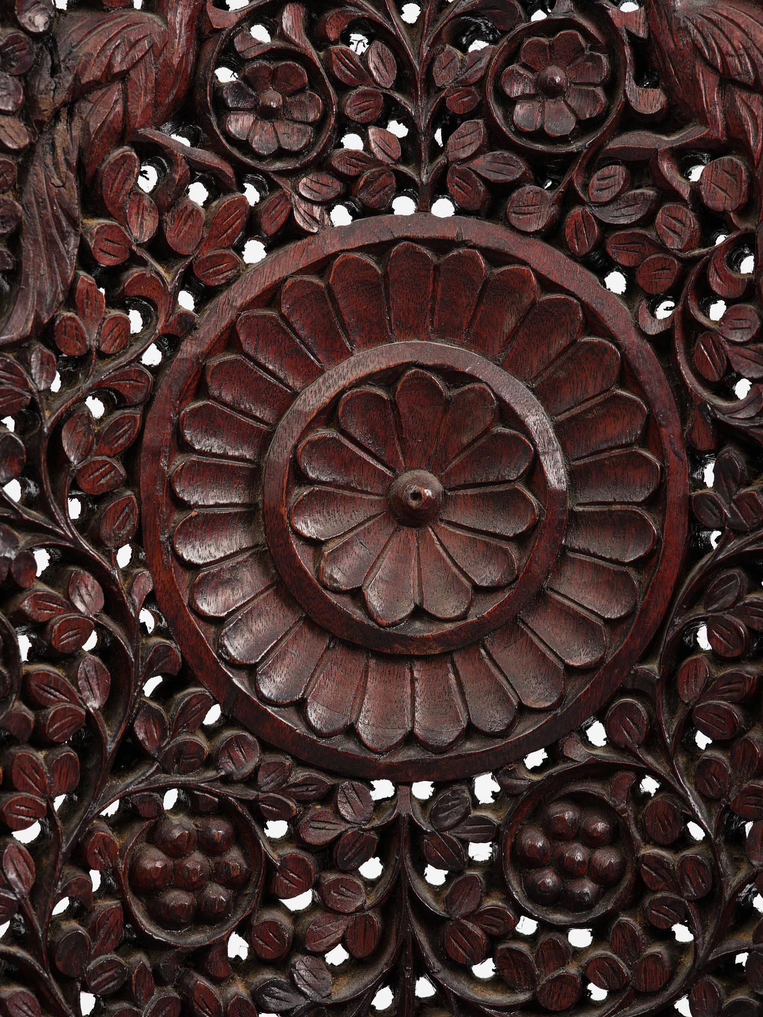 A pair of carved 'blackwood' armchairs, Bombay presidency, British Raj, circa 1880.