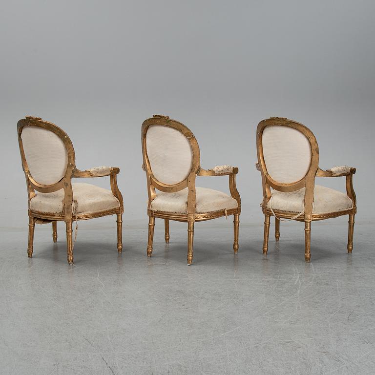 An early 20th century Louis XVI-style sofa and three chairs.