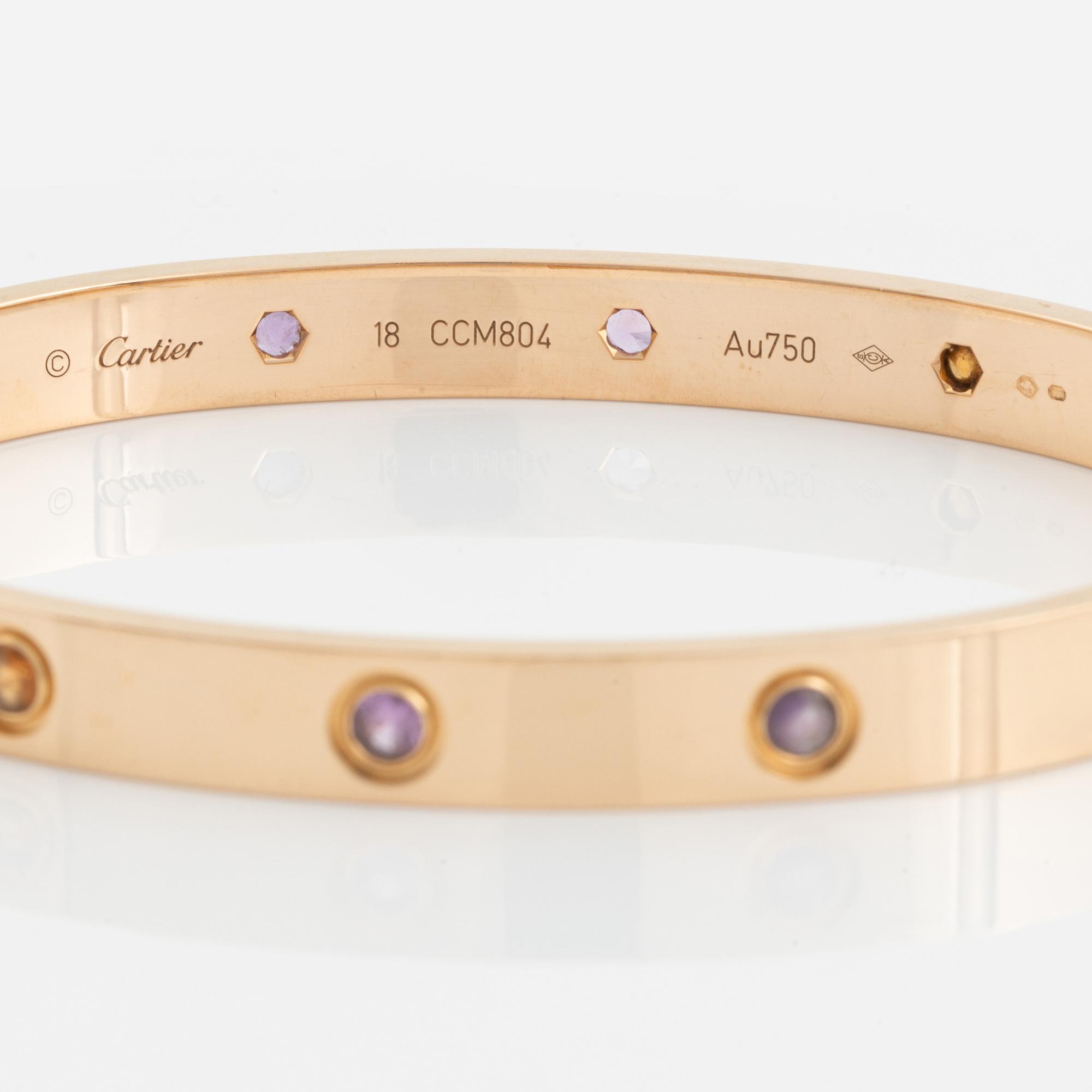 A Cartier "Love" bracelet in 18K rose gold set with colored stones.