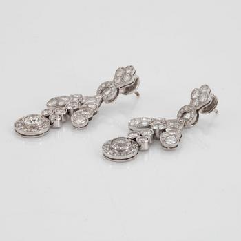 A pair of 18K white gold earrings set with old- and round brilliant-cut diamonds.