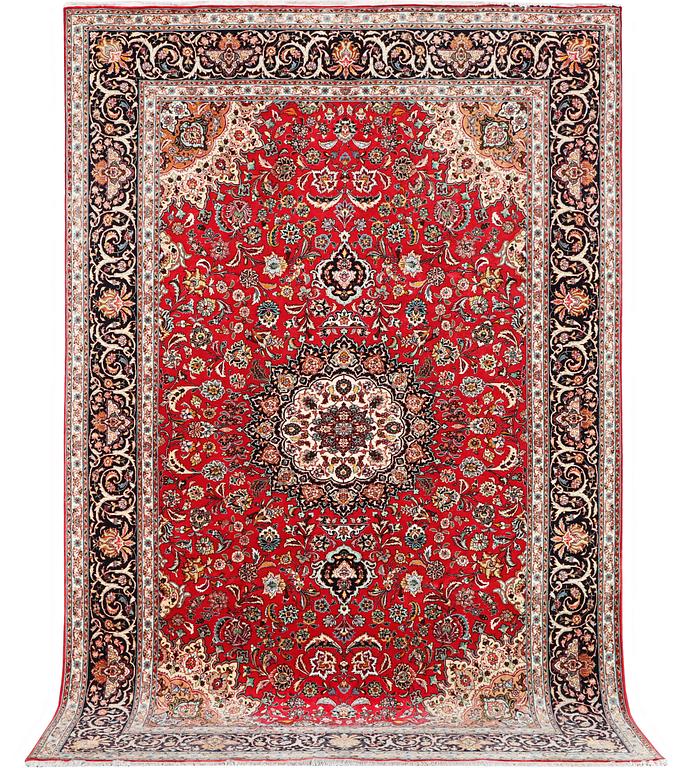 A Tabriz carpet, part silk, 50 raj, c. 325 x 208 cm.