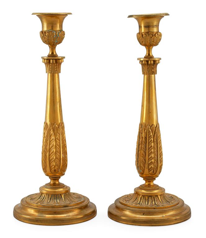 A PAIR OF EMPIRE CANDLESTICKS.