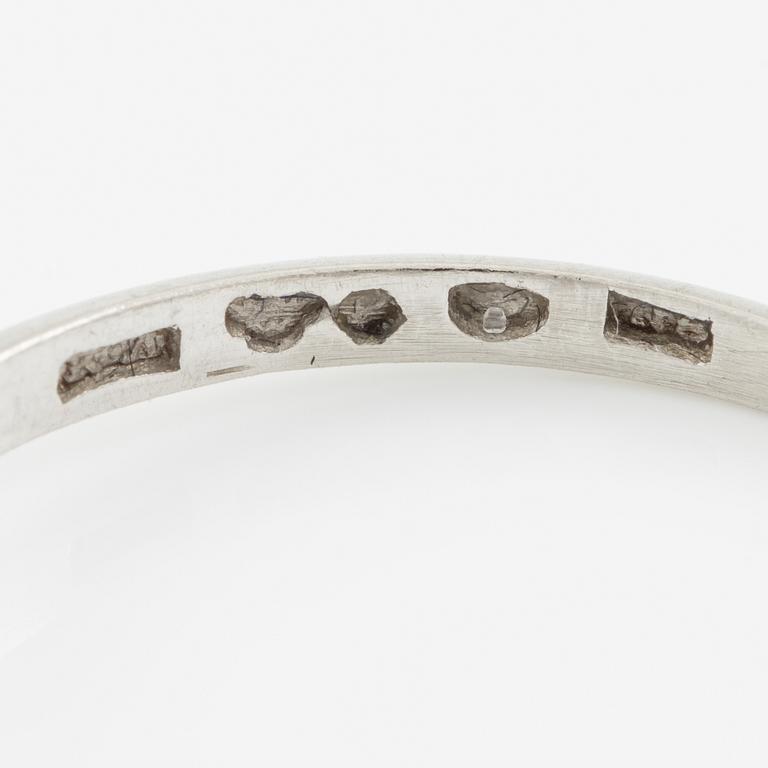 Platinum ring with brilliant-cut diamond.
