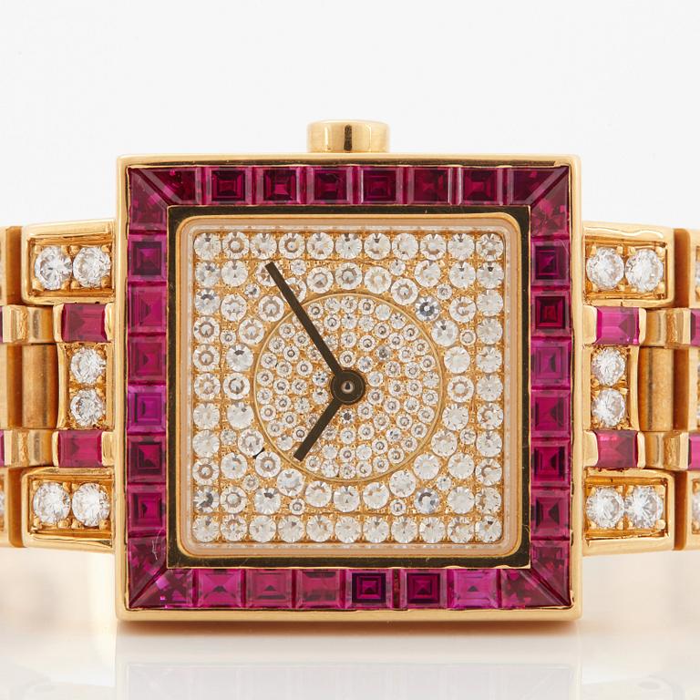 A Bulgari wristwatch in 18K gold set with step-cut rubies and round brilliant-cut diamonds.