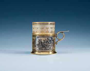 1197. A RUSSIAN SILVER-GILT AND NIELLO TEA GLASS-HOLDER, unidentified makers mark, Moscow 1872.