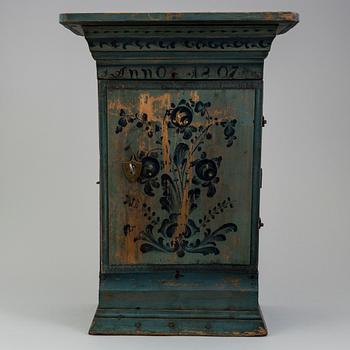 a oainted swedish wood wall cabinet, dated 1807.