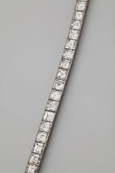 A platinum bracelet set with carré cut diamonds.