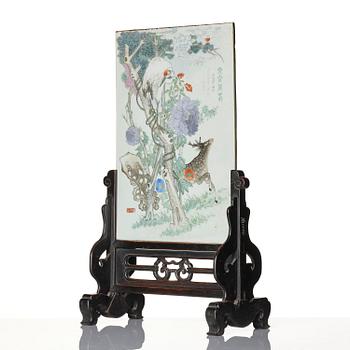 A Chinese famille rose porcelain table screen with hardwood stand, 20th century.