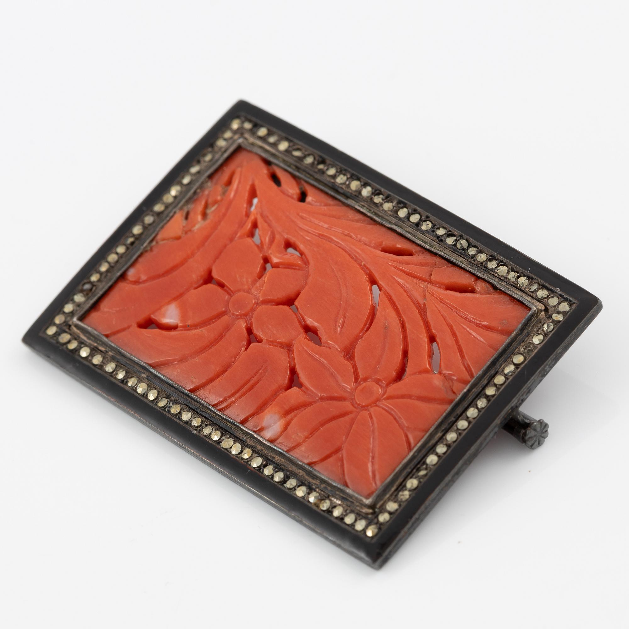 Brooch in silver with coral and marcasites, and with black details.