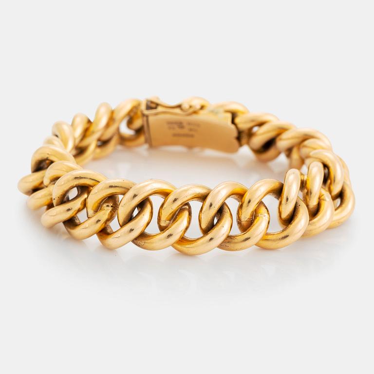 An 18K gold bracelet.