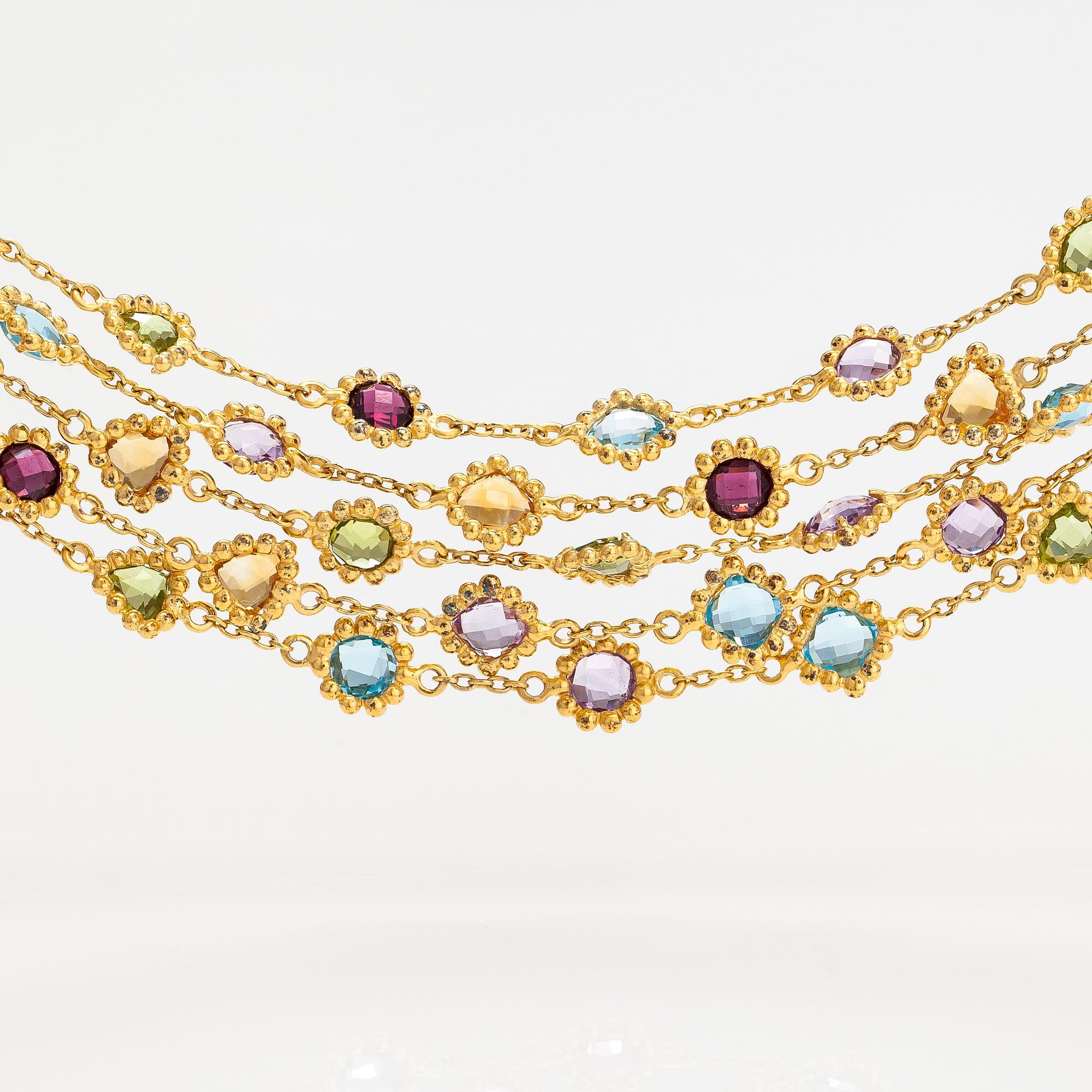 A gilded silver bracelet with topazes, garnets, peridotes, amethysts and quartzes.