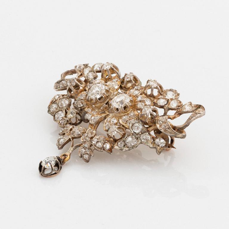 A silver brooch set with old-cut diamonds.