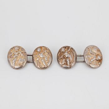 A pair of cherub motif cufflinks by Alfred Philips.