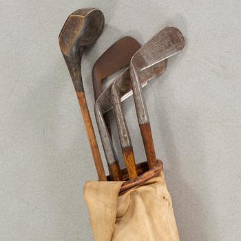 Five early 20th century golf clubs and bag.