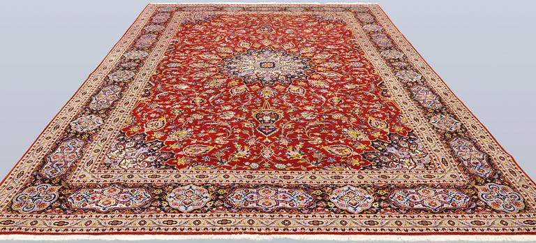 A Keshan carpet, part silk, signed, approx. 398 x 270 cm.