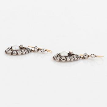 A pair of silver and gold earrings set with old-cut diamonds and pearls.