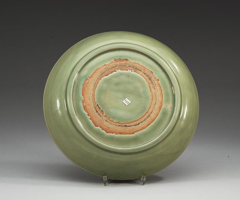 A celadon charger with a double-vajra medallion, Ming dynasty (1368-1644).