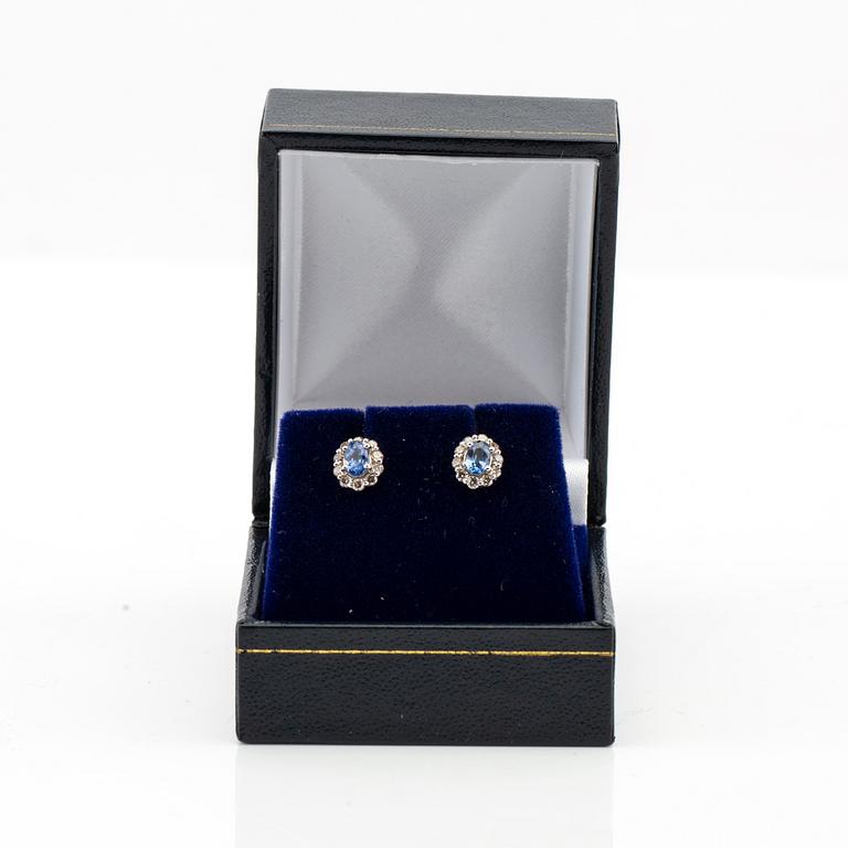 Earrings in 18K white gold with oval faceted sapphires and round brilliant-cut diamonds.