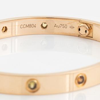 A Cartier "Love" bracelet in 18K rose gold set with colored stones.