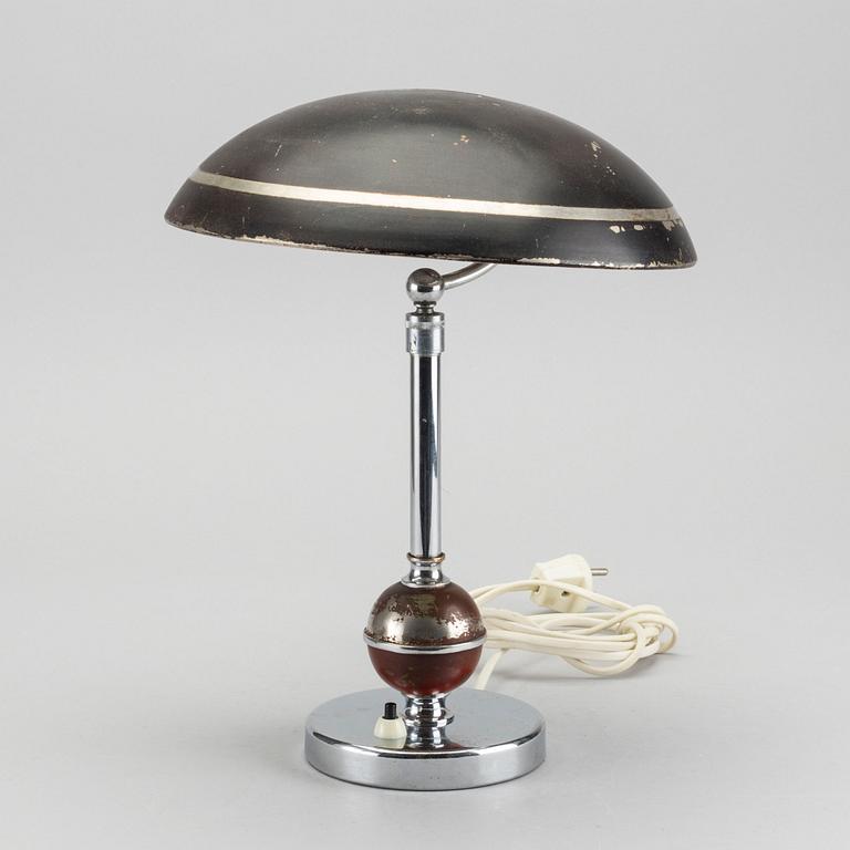 A 1930's white metal table lamp.