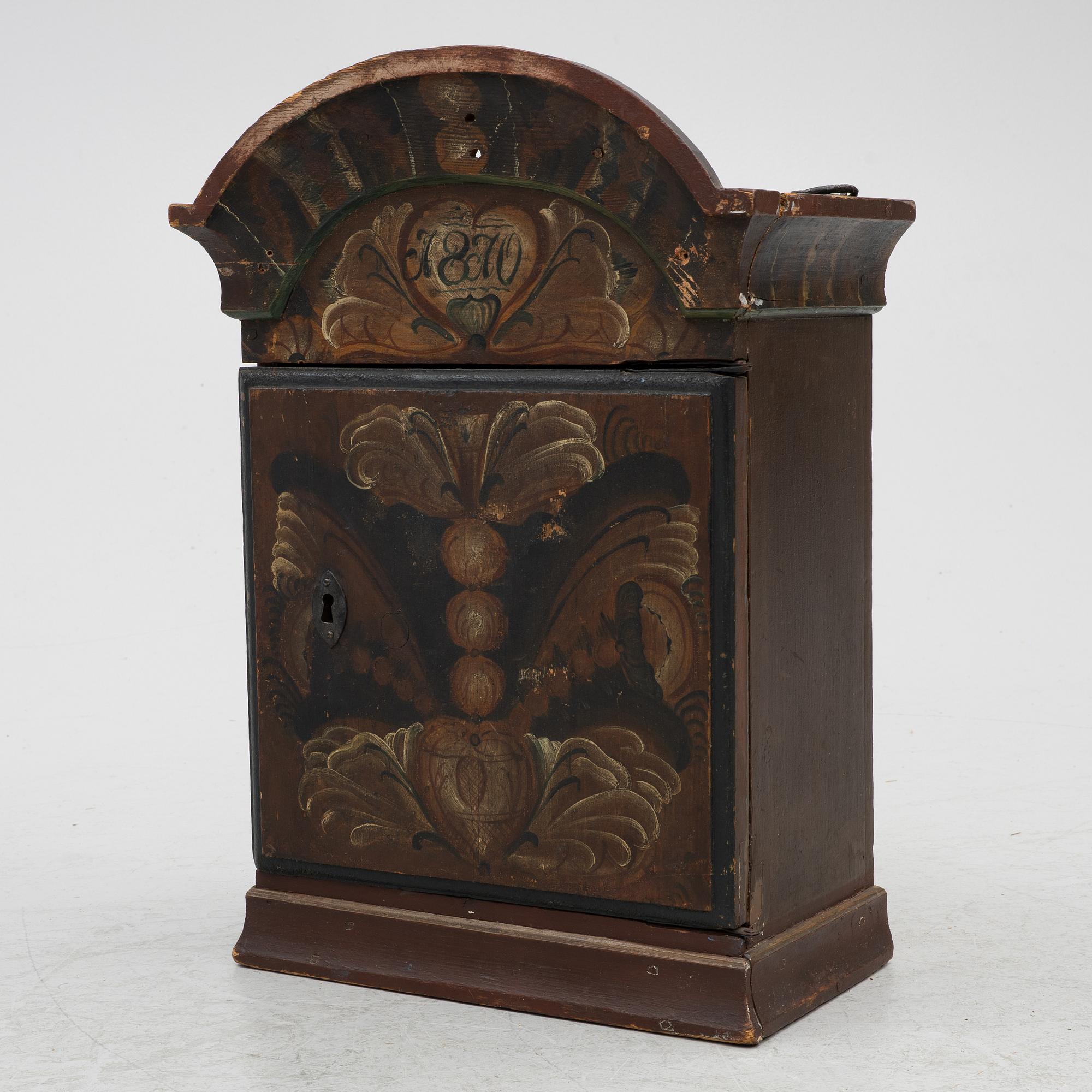 A hanging cabinet, dated 1870.