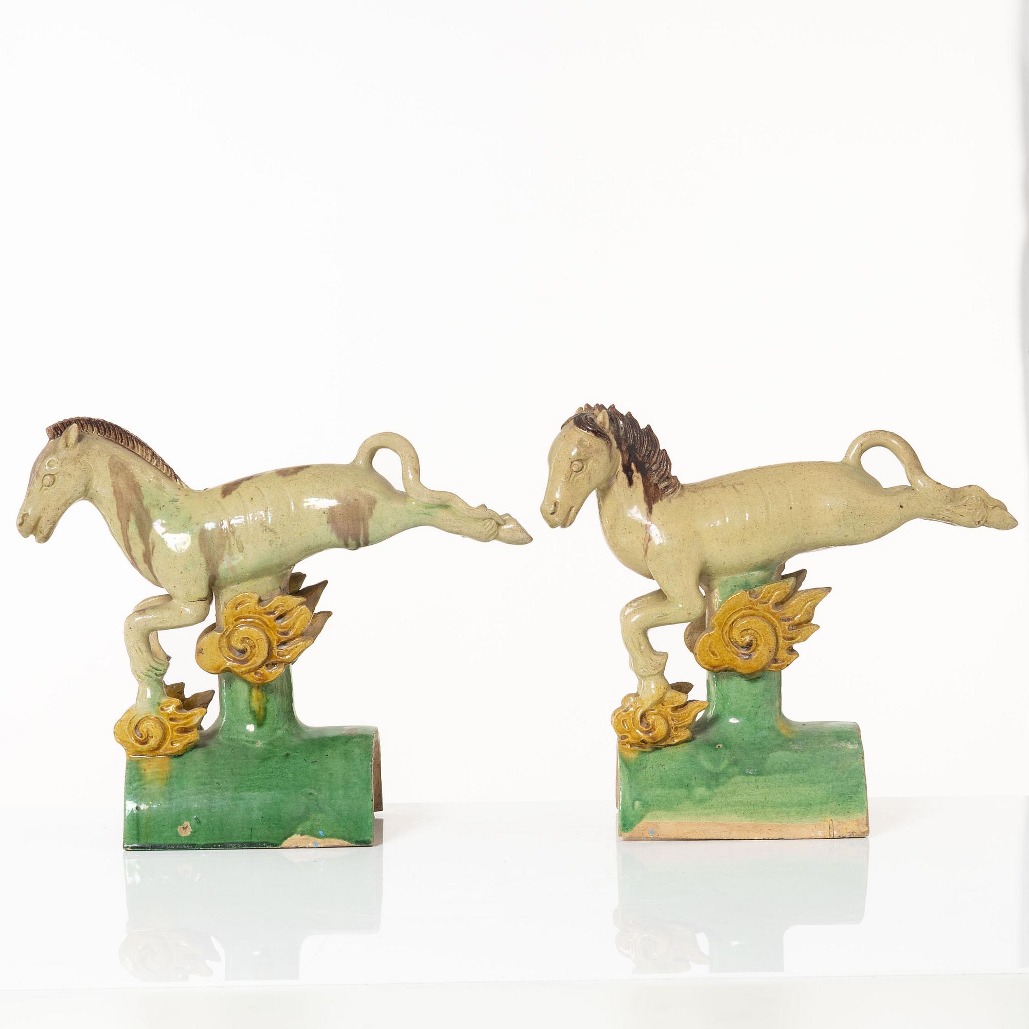 A set of two green and yellow glazed roof tiles figures of flying horses, Qing dynasty.