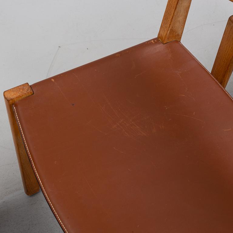 Four oak chairs with leather seat by John Vedel Rieper, Denmark, 1962.
