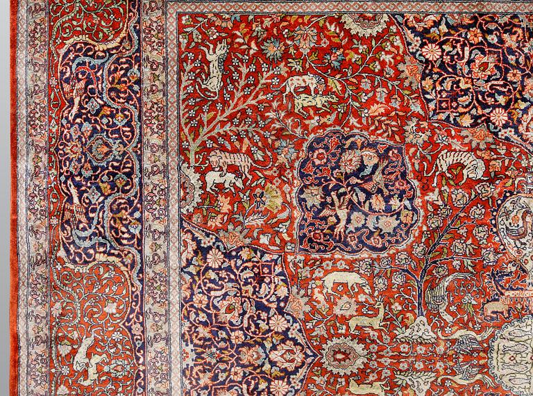 A pictoral orietal silk rug, 246 x 153 cm.