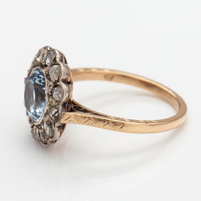 A 13-14K gold ring with a synthetic spinelle and rose-cut dimaonds.