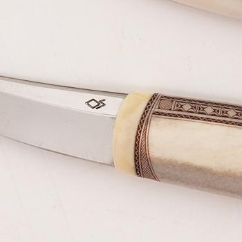 A reindeer horn knife by Olav Svonni, signed and dated 2000.