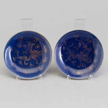 A pair of Chinese powder blue porcelain cups with dishes, Qing dynasty, Qianlong (1736-95), with Qianlongs mark.