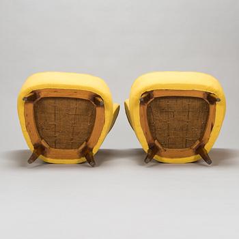 A pair of mid-20th-century armchairs.