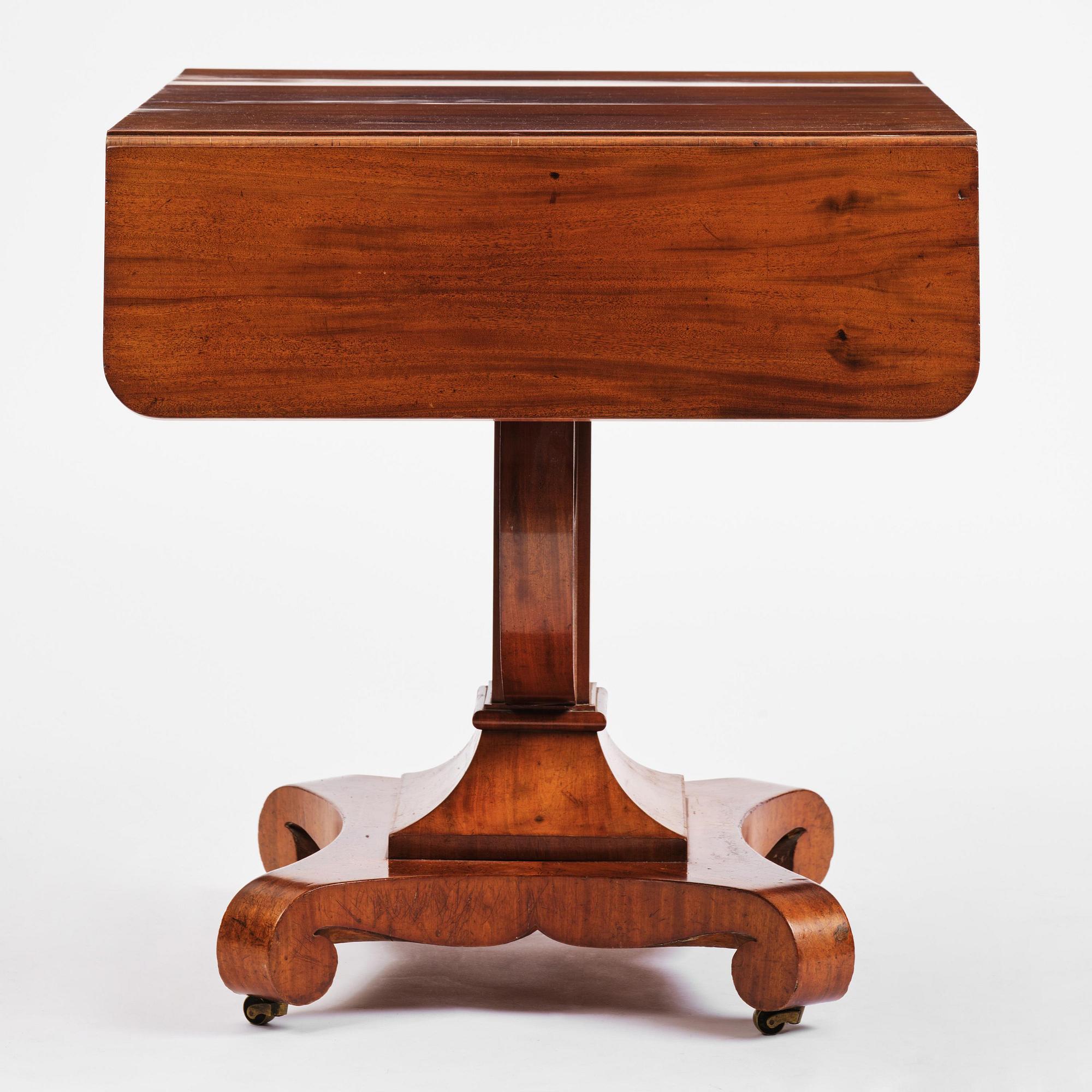 A Swedish Empire mahogany center table.