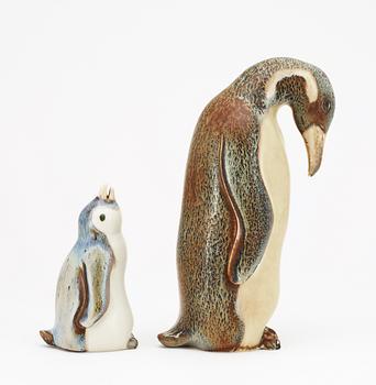 Two Gunnar Nylund stoneware figures depicting a penguin mother with child, Rörstrand.