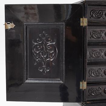 A South-German Baroque ebonized collector's cabinet on stand, circa 1700.