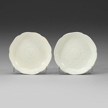 89. A pair of white-glazed small moulded dishes, Qing dynasty, Yongzheng six-character mark and of the period.
