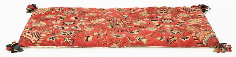 An embroidered carrige cushion, c. 92 x 52 cm, Scania, Sweden, dated 1848.