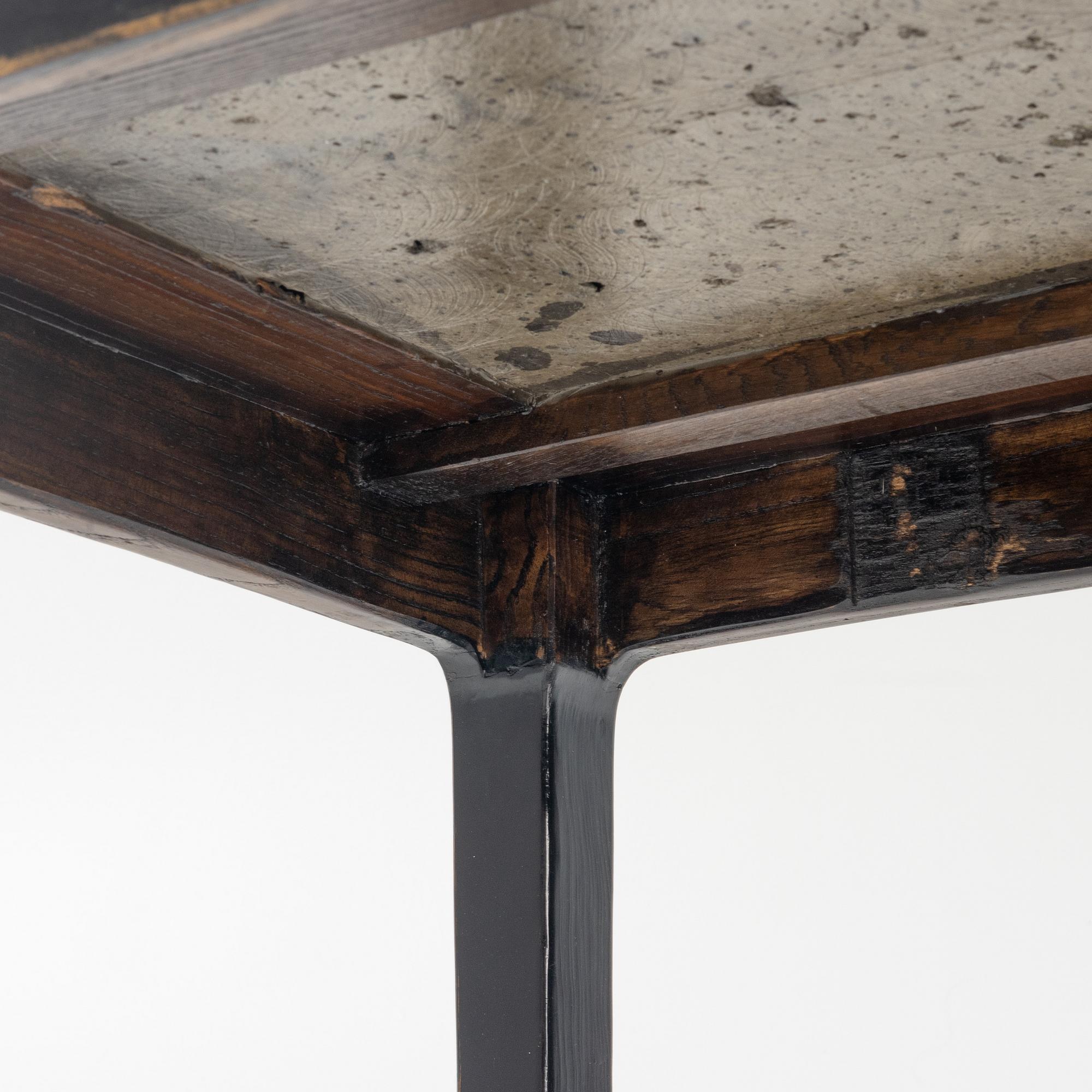 A pair of blac painted side tables with stone tops.