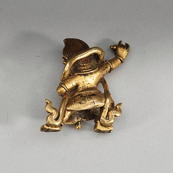 A Sinotibetan gilt bronze miniature standing figure of a Dharmapala, presumably 18th Century.