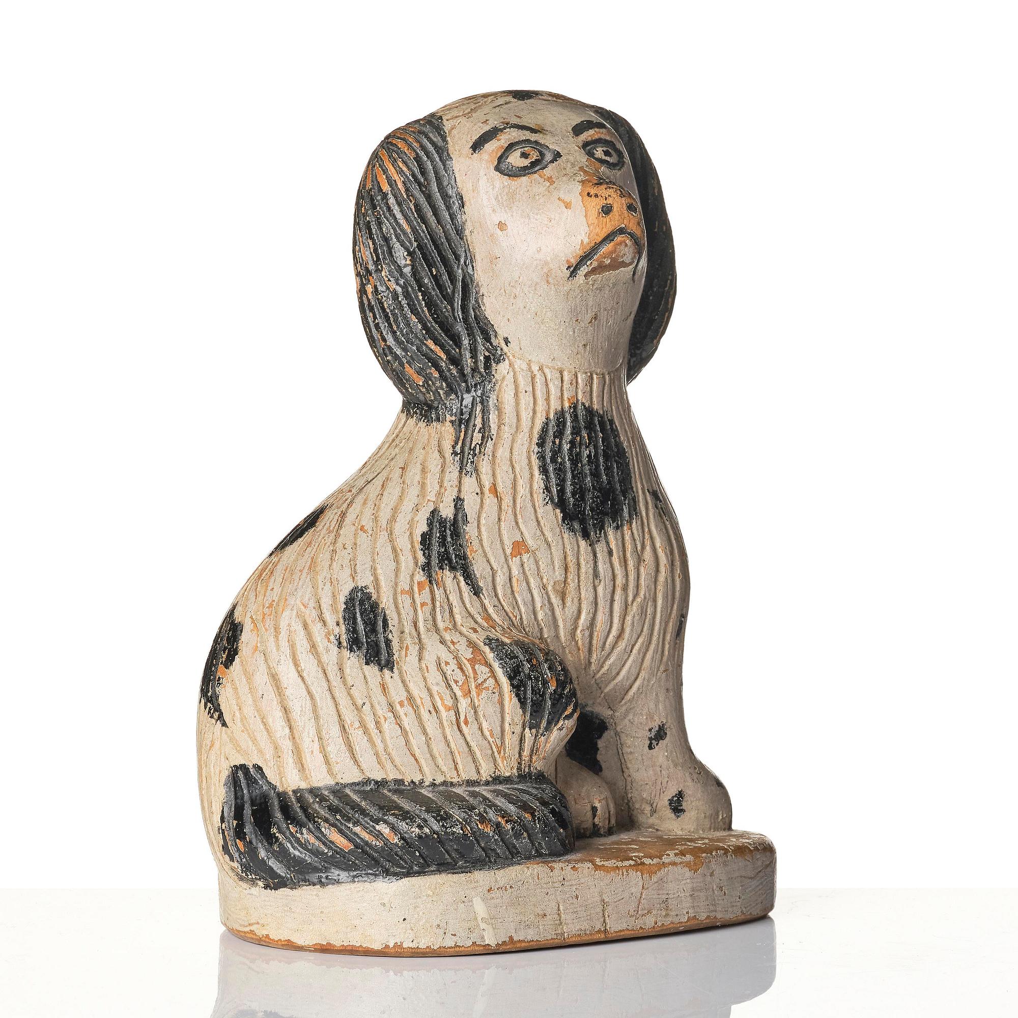 A Swedish wooden folk-art sculpture depicting a 'Staffordshire dog' ceramic figurine, 19th century.