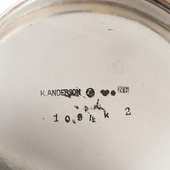 Three Silver Shakers and a Beaker.