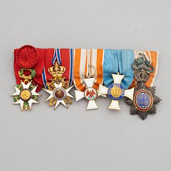 A set of five Knight's badges.